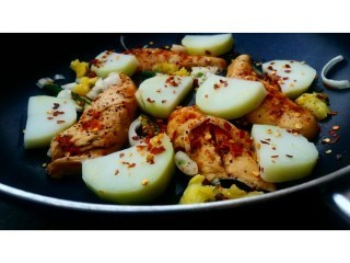 Pan Fried Chicken Breast Fillets With Potato Slices.