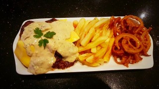Cheddarmelt Steak Served With Onion Rings
