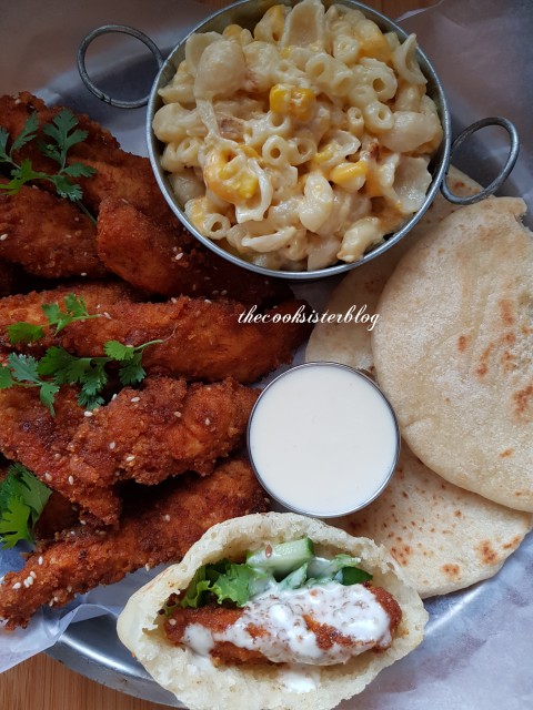 Chicken Strips Served With Macaroni And Cheese.