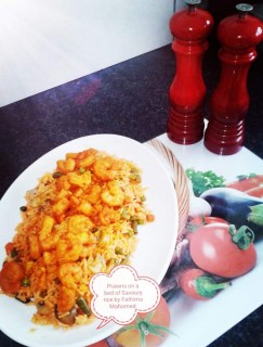 Prawns Grilled Creamy Tomotoes In Garlic  Butter Based Sauce On A Bed Of Savoury Rice.