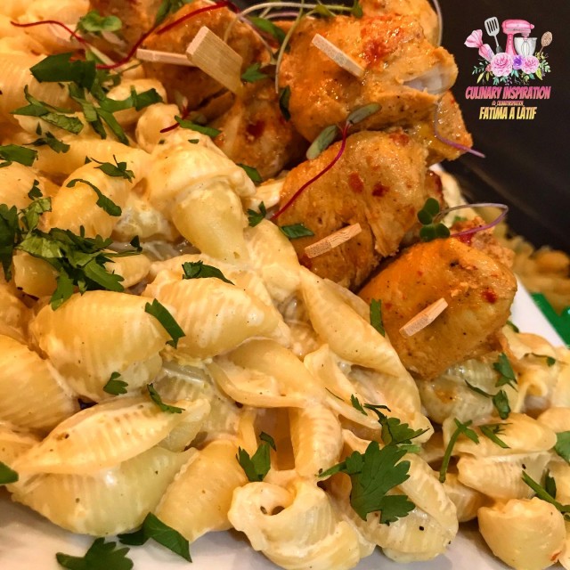 Chicken Skewers Set On A Bed Of Creamy Pasta